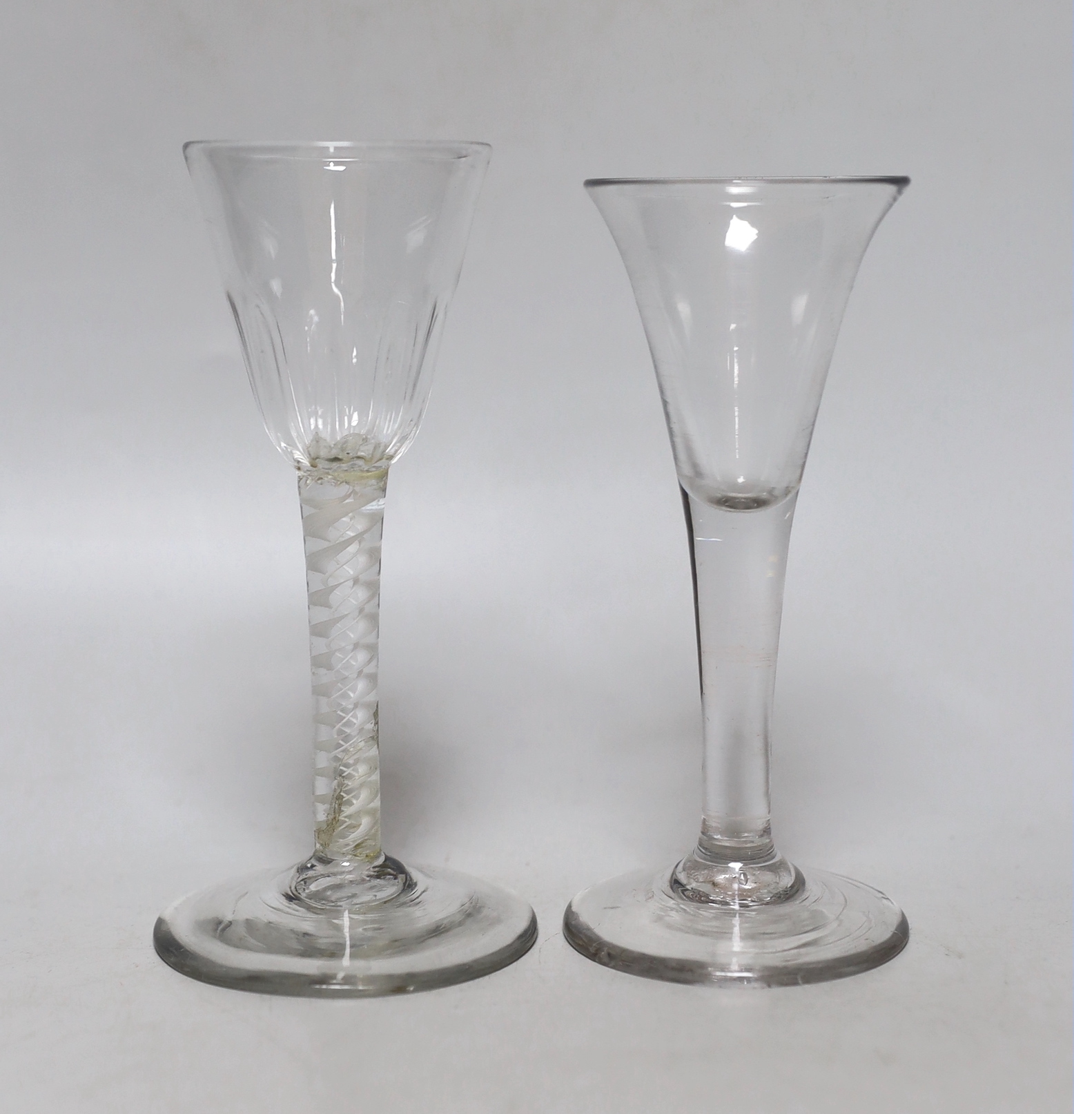 Two Georgian glasses including one with a double series opaque twist stem, the largest 15cm high